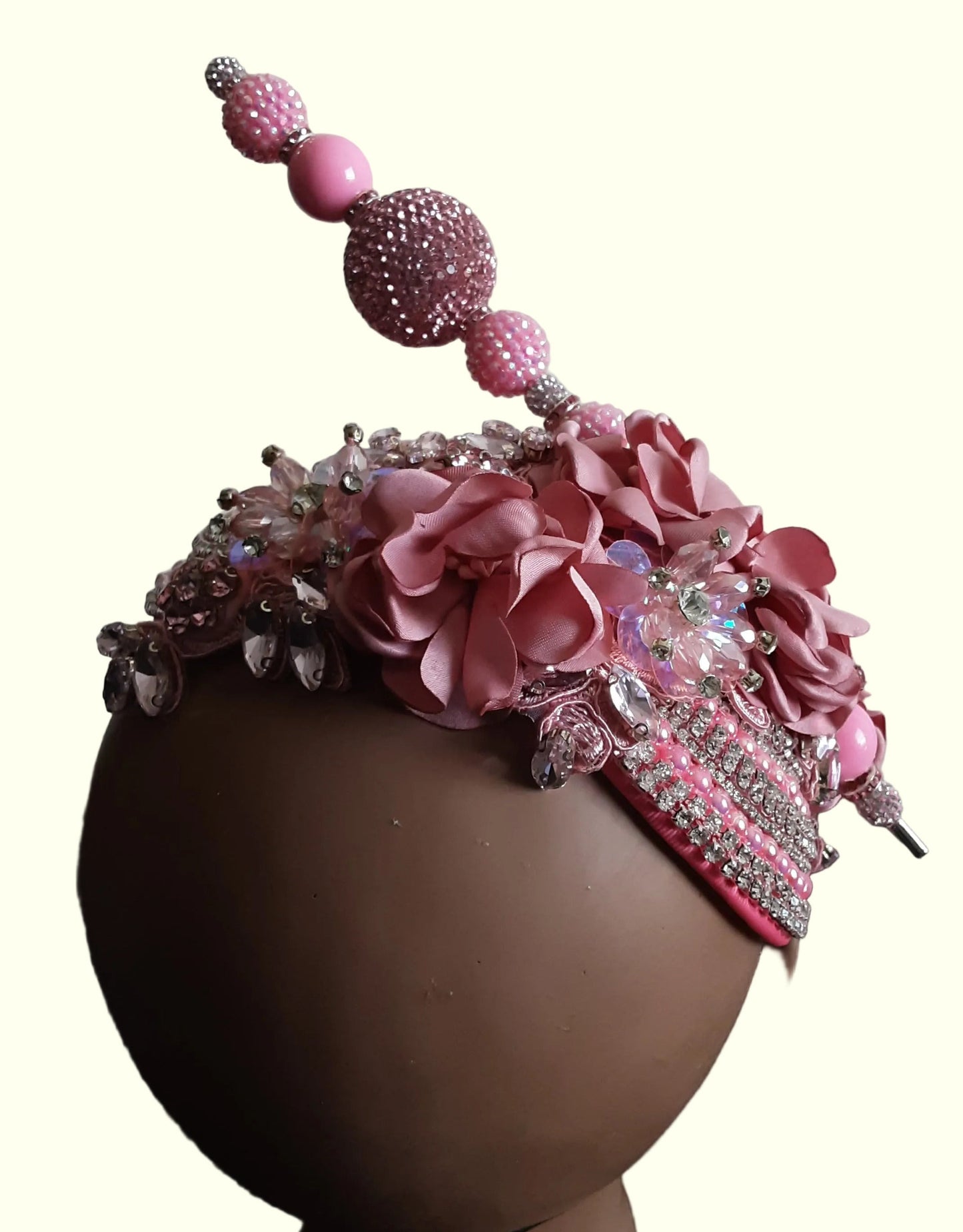 Pink church hat fascinator with decorative feathers and netting, elegant formal accessory for weddings, church, and special events.