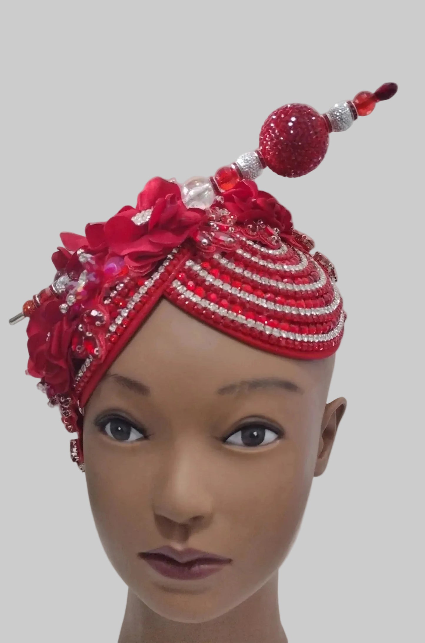Red handcrafted church hat fascinator with floral and rhinestone details, featuring elegant design and decorative feathers.